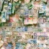 10 and 10 banknotes on brown wooden table