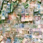 10 and 10 banknotes on brown wooden table